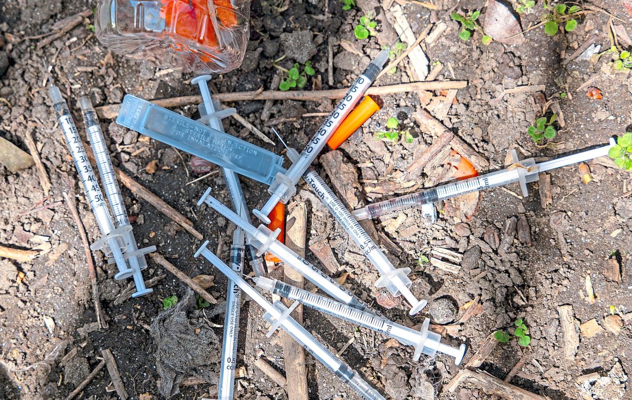 Dirty needles collected by outreach workers as they participate in a weekly needle clean-up at a Bronx park in New York City, which has one of the highest overdose rates in the US. — Spencer Platt/Getty Images/TNS