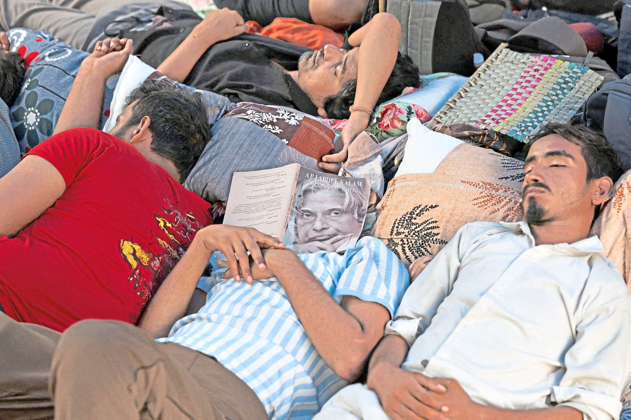 CJP supporters at a sit-in protest called by the party demanding the resignation of Pradhan, at Jantar Mantar in New Delhi. — Reuters