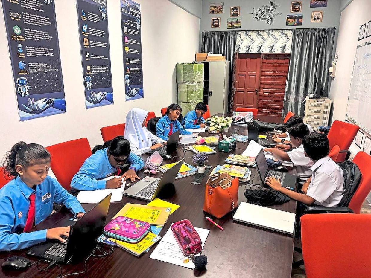 Pupils at SJK (T) Jalan Parit Ibrahim utilise individual laptops during an AI-powered classroom session at their school in Pontian, Johor.