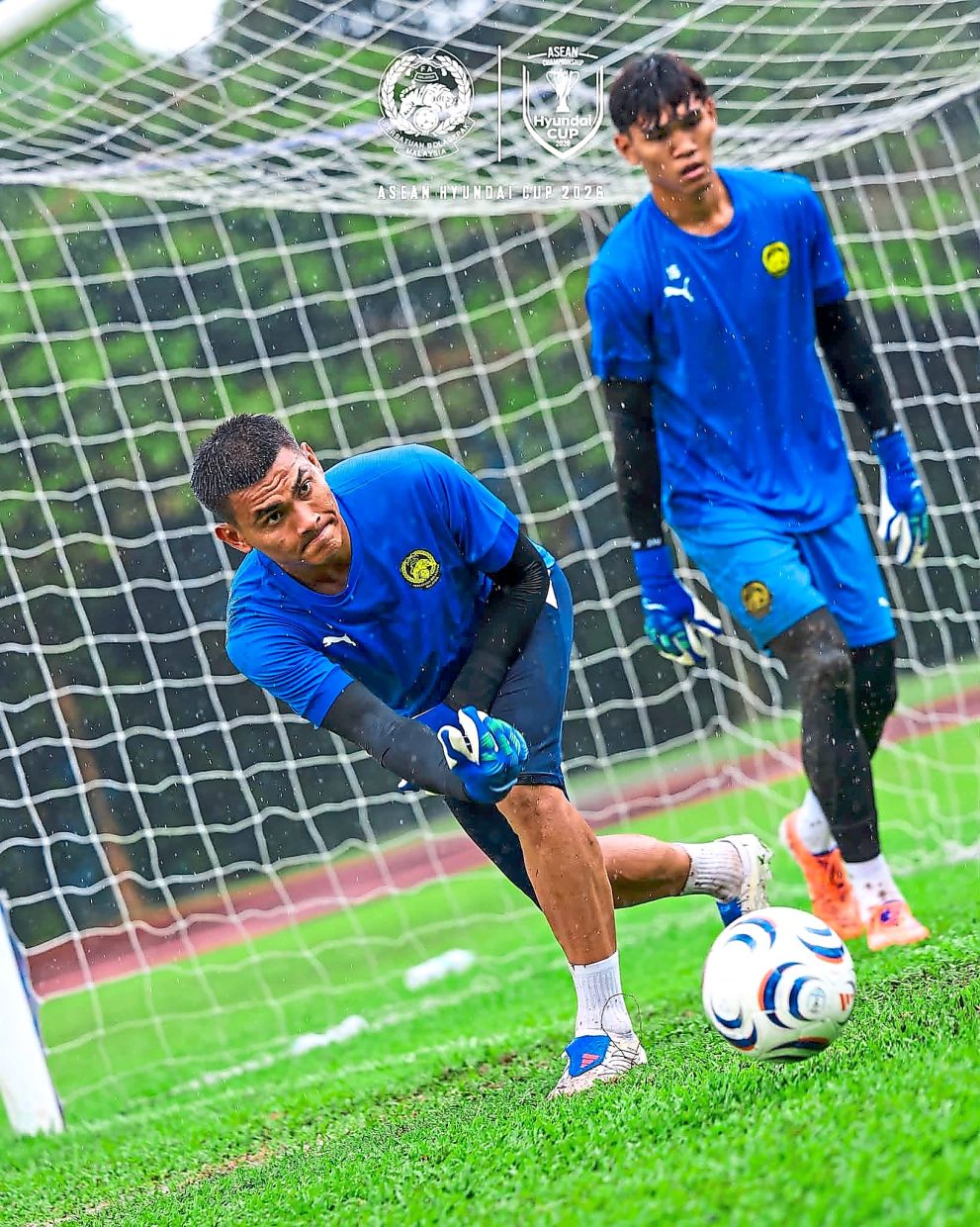 Tall order: Azri Ghani (left) in action during training while his teammate looks on. — Malaysia NT