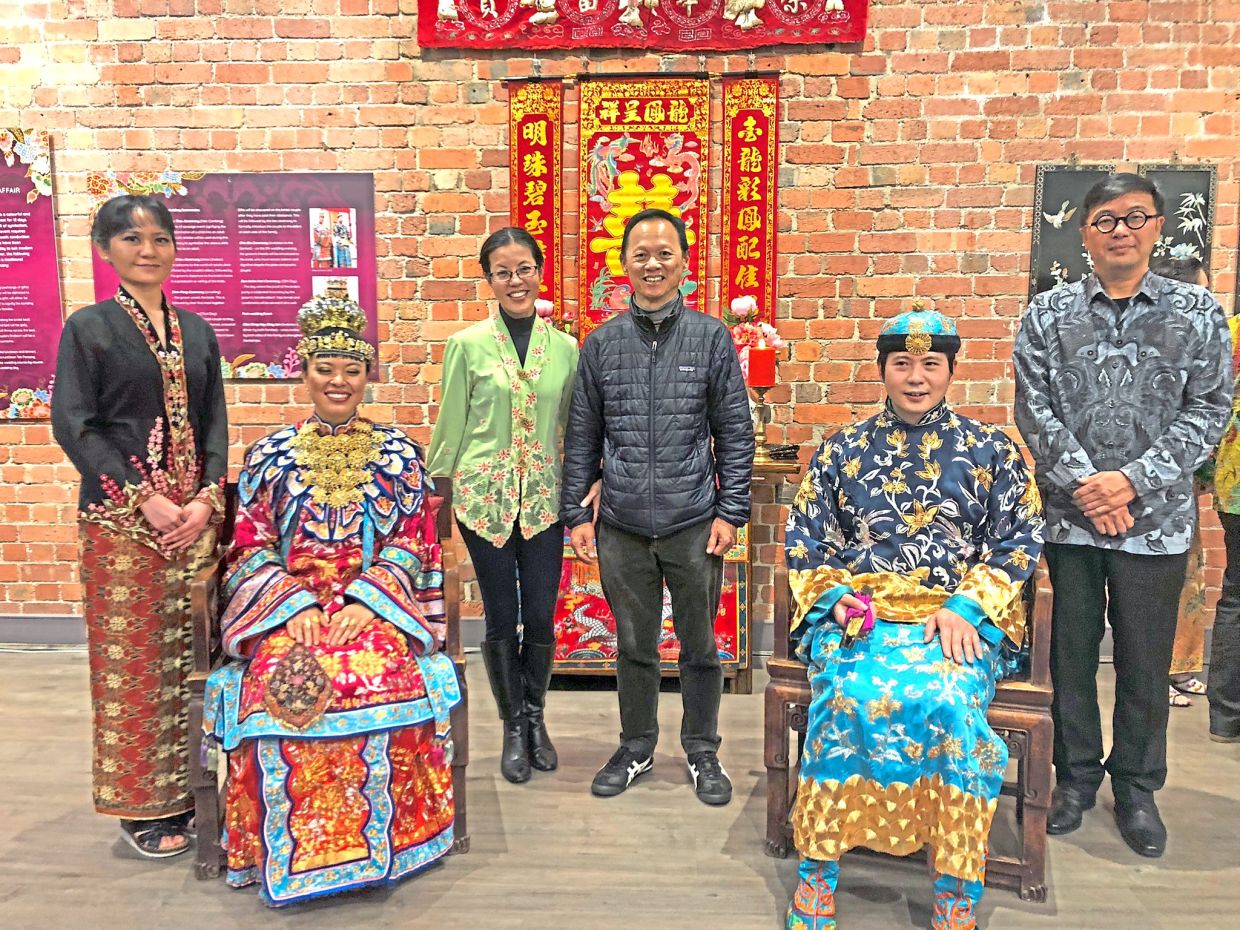 Tan and her husband, See Hunt Soon (centre), at a traditional Peranakan wedding ceremony demonstration in Melbourne, Australia organised by the Peranakan Association of Australia.