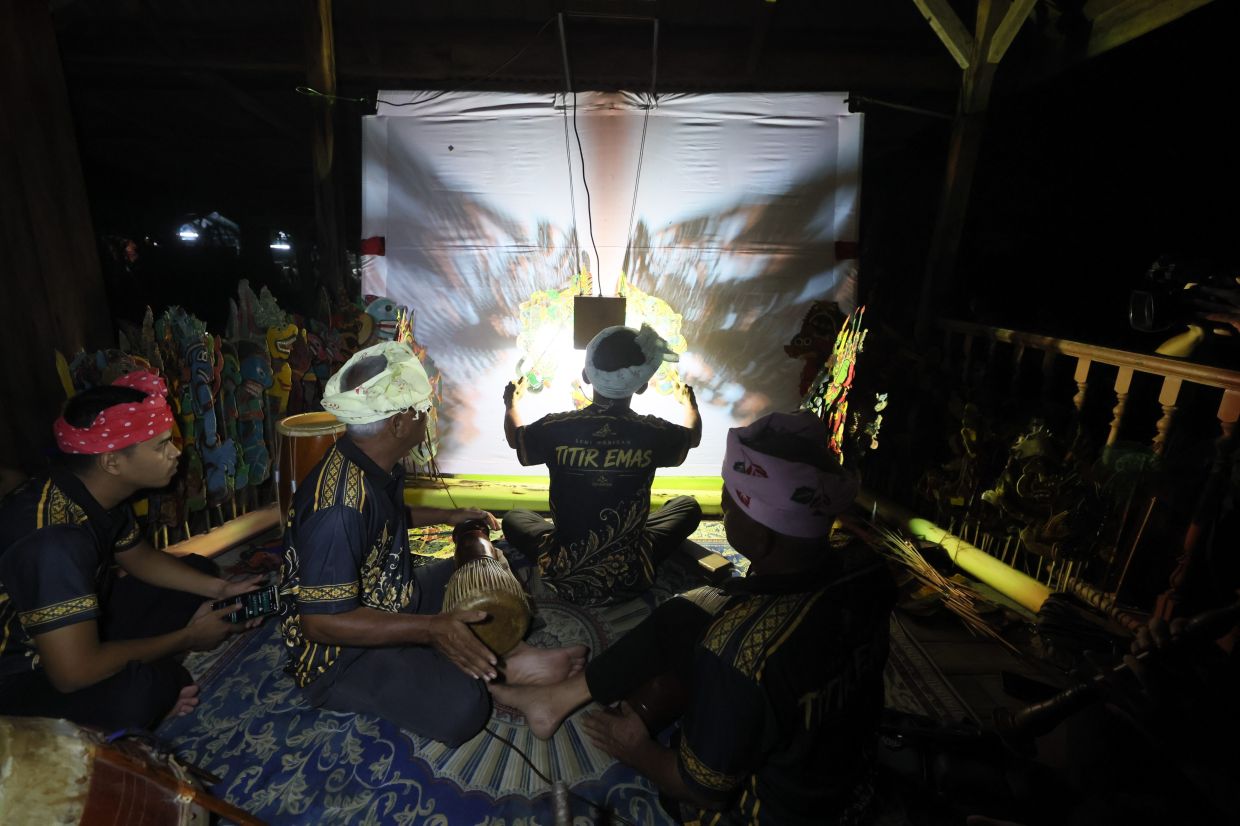 In a wayang kulit performance, the Tok Dalang must ensure every character's movement is synchronised with the music while overseeing the instruments and ensuring the performance runs smoothly. Photo: Bernama 