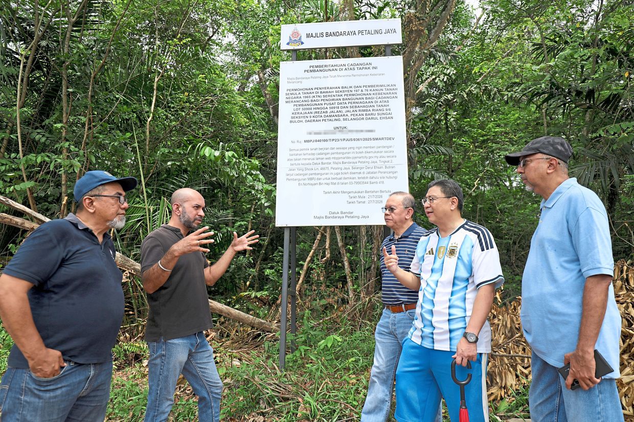 (From left) Mohd Razif, Narindera and Foo with other residents from the coalition discussing concerns over the proposed data centre.