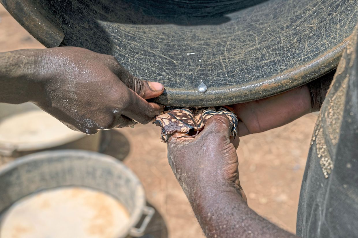 Abimana holding a piece of mercury containing gold that he collected from the Maidede mining quarry near Mongbwalu. The lure of lucrative wages draws miners to the area.— Arlette Bashizi/The New York Times