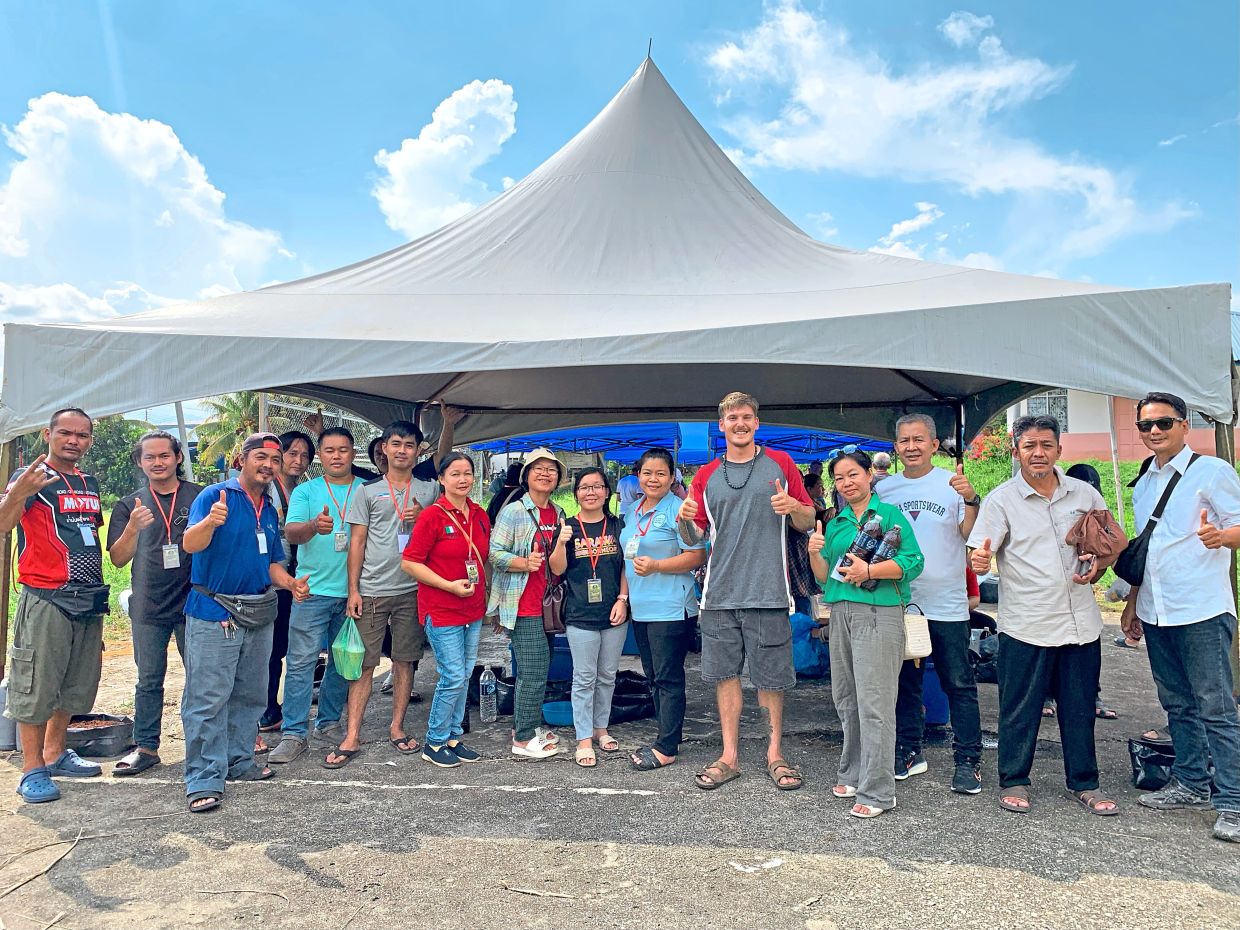 Oli (fifth from right) has fully embraced kampung life in Borneo. — OLIVIER MAILHOT