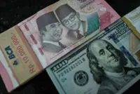 Emerging Markets -Singapore dollar jumps on surprise tightening; rupiah sinks as governor quits