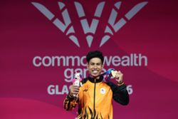 Aznil lifts historic third straight Games gold in record style