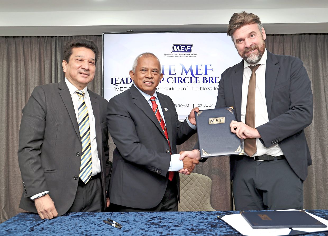 Future forward: Prof von Scheel (right) and Rosman (centre) shaking hands during the MEF Leadership Circle Breakfast dialogue session in Petaling Jaya. — ART CHEN/The Star
