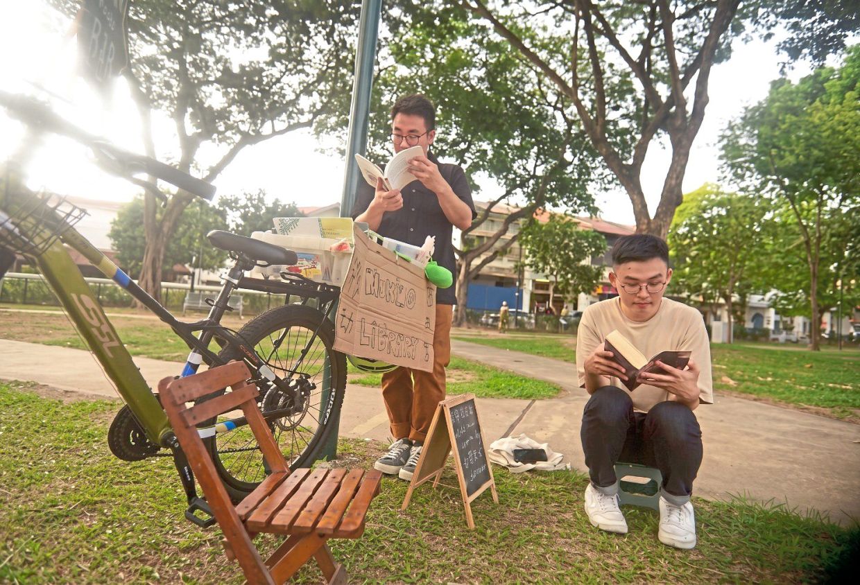 Book lovers immerse themselves in titles selected from a mobile library set up by Tan at Armenian Park during a World Book and Copyright Day event in April. — Courtesy of BOOKS R&R