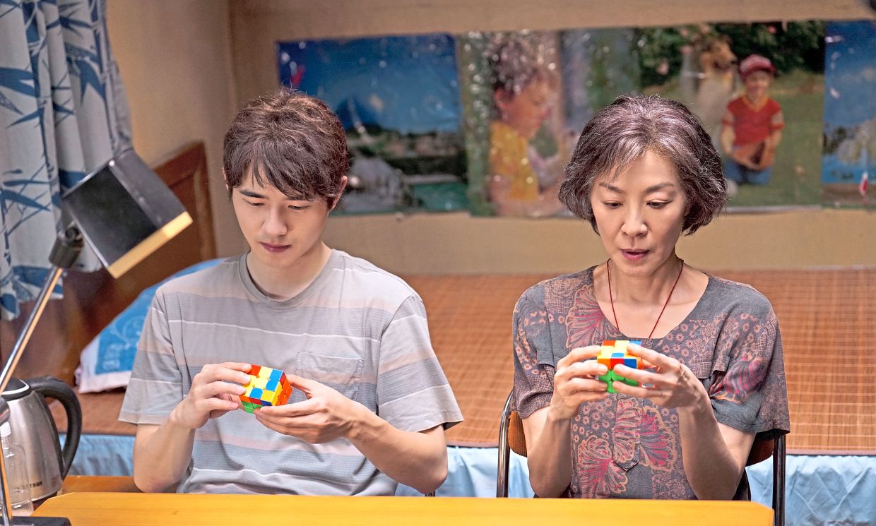 To ensure she got the movements of the hands right, Michelle Yeoh (right) – with co-star Liu Haoran – practised with the puzzle cube close to two years. Photo: Handout