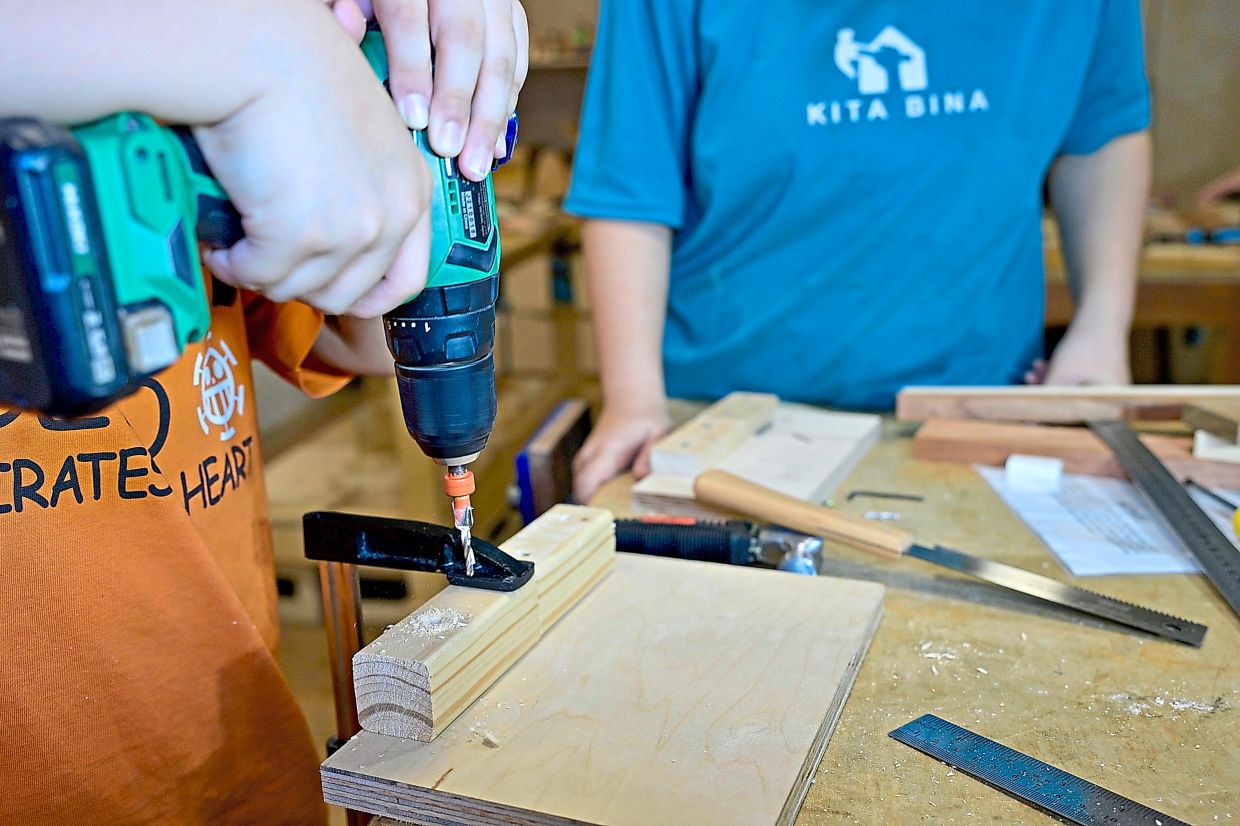 The junior programme swaps heavy machinery for safer hand tools without losing any of the hands-on learning. Photo: The Star/Raja Faisal Hishan