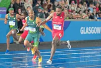 Eseme and Hobbs defy downpour to grab 100m golds