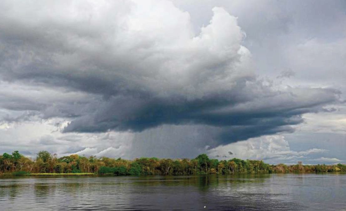 Rain falling on the Xingu River in the Kayapo Indigenous territory near the village of Metuktire, in the Amazon rainforest of Mato Grosso state, Brazil. — AFP