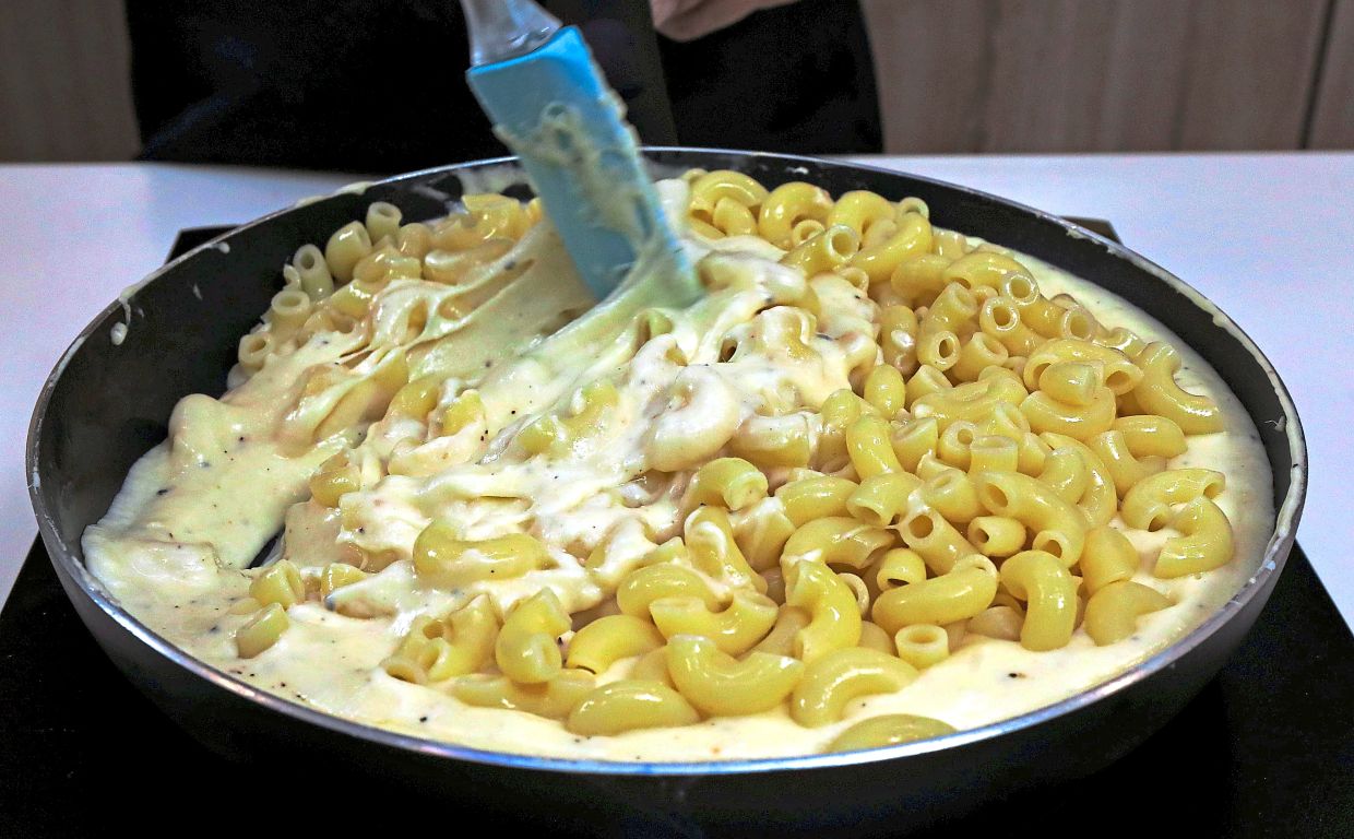 Fold the macaroni into the warm cheese sauce.
