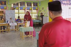 Negri polls: Bride turns heads as she votes in wedding attire