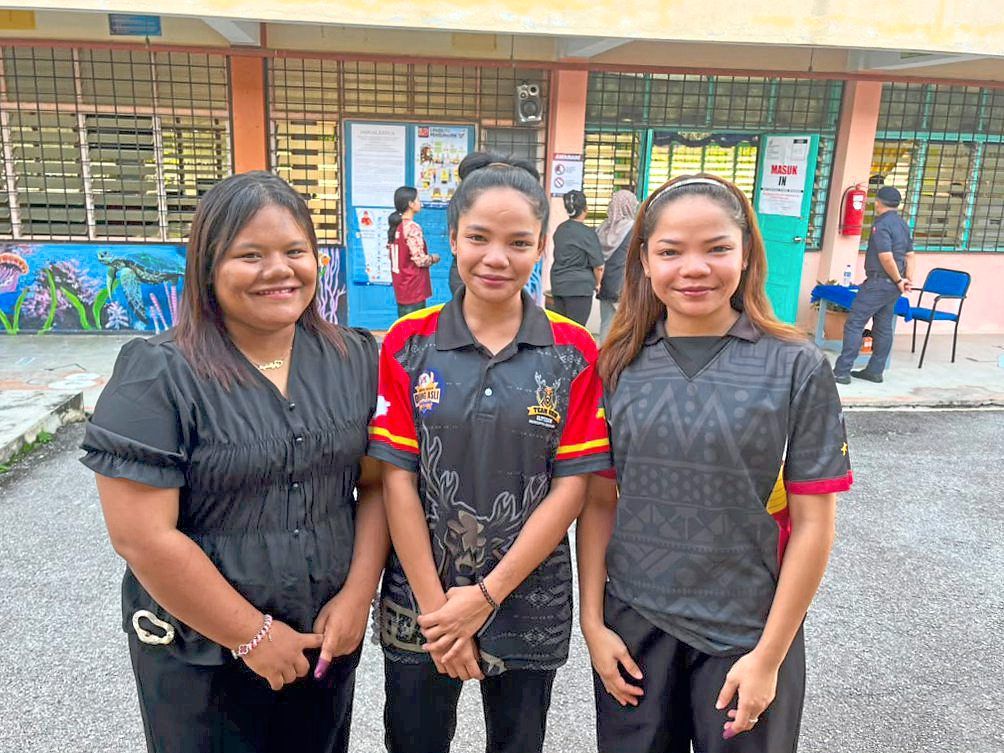 Best friends since they were toddlers, Norazlin Abdullah (left), 25, and twin sisters Asmissa Syafina Assemi (centre) and Asmissa Sakina Assemi, both 25, pose for a photograph after arriving together to cast their ballots at the Sekolah Kebangsaan Putra polling station in Simpang Durian during the Negri Sembilan state election yesterday. — ARFA YUNUS/The Star