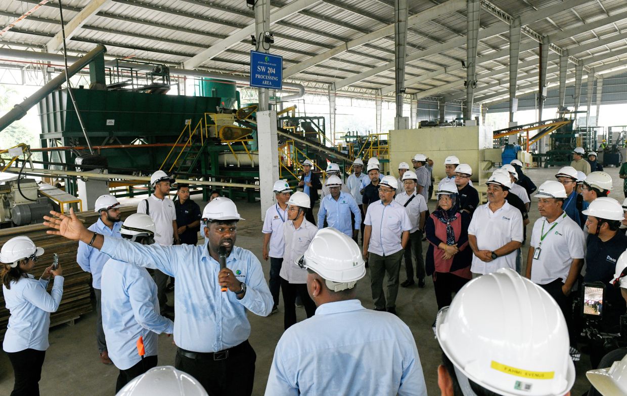 Karthigayan explaining the brick making process. — Photos: Bernama