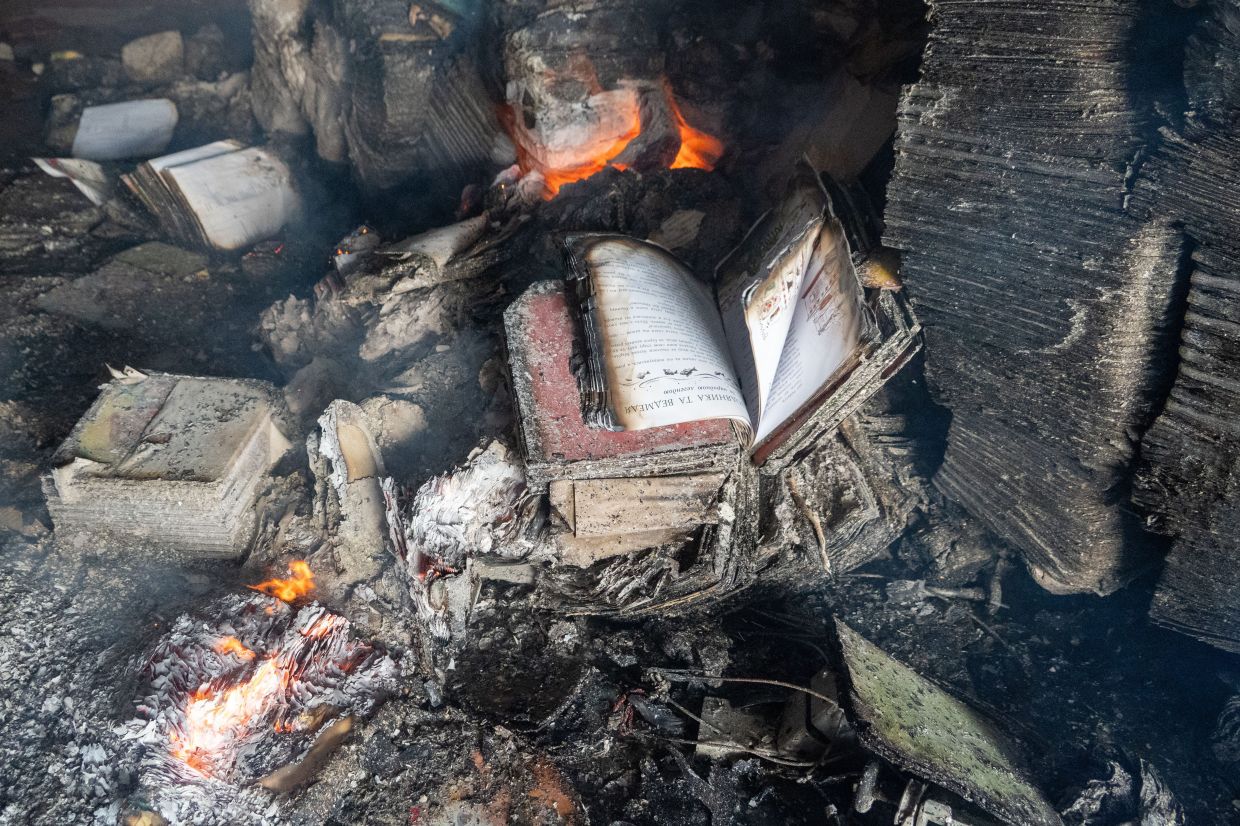 Books burn in the fire at a major book warehouse following Russian drone strikes in Kharkiv, Ukraine. Photo: AP