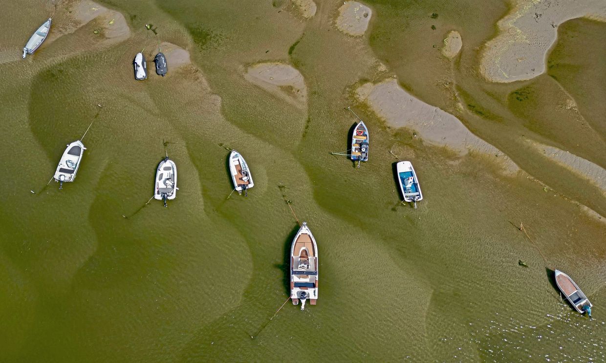 An aerial view showing boats in the shallow water of the Danube in Corabia.