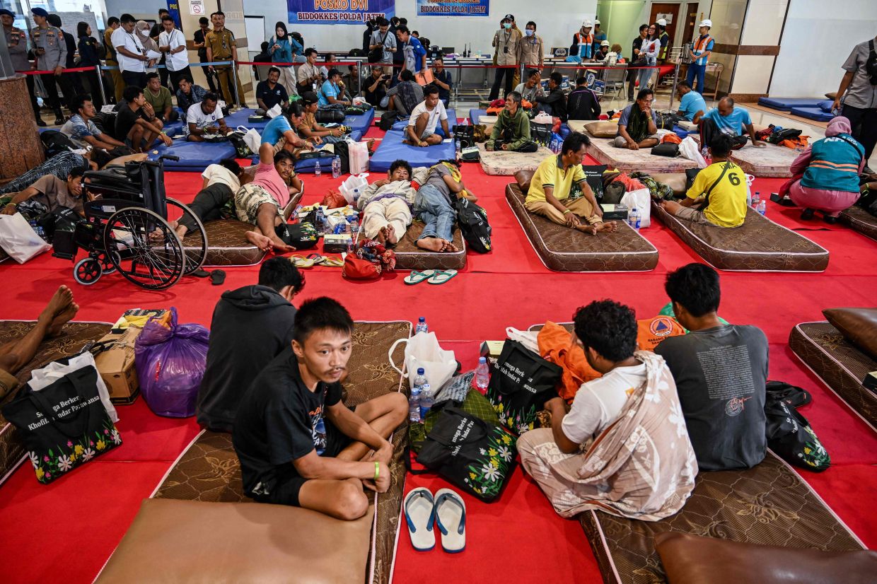 Survivors rest at Tanjung Perak port pier after arriving on board the Masalembu government vessel in Surabaya on Tuesday, August 4, 2026, following a fire on board the Mutiara Sentosa 2 passenger ferry in waters off Madura island on August 2. -- Photo by JUNI KRISWANTO / AFP