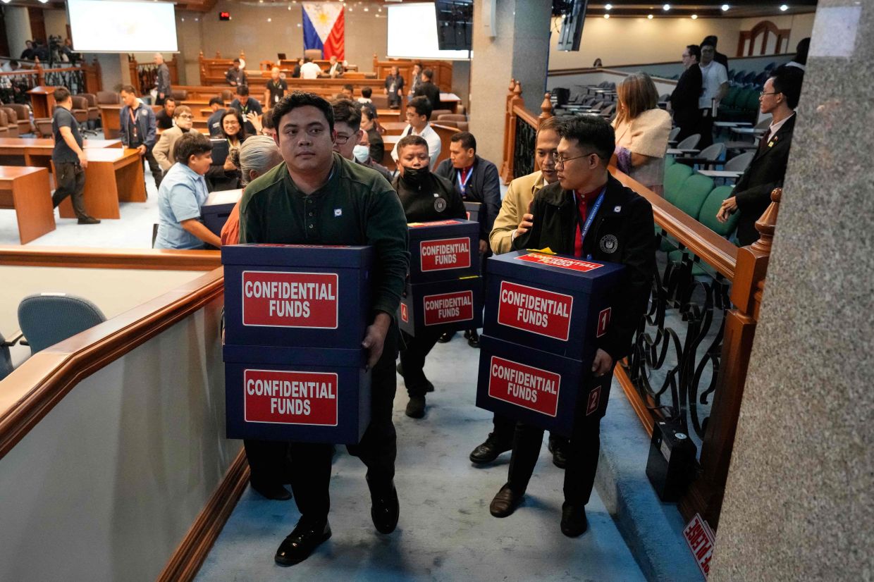 Workers carry boxes labelled confidential funds containing documents that were presented during the impeachment trial of Philippine Vice President Sara Duterte at the Philippine Senate in Pasay City, Metro Manila, on Tuesday, August 4, 2026. -- Photo by Aaron Favila / POOL / AFP