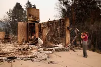 Wildfires near Spokane destroy more than 700 buildings, force 64,000 to flee