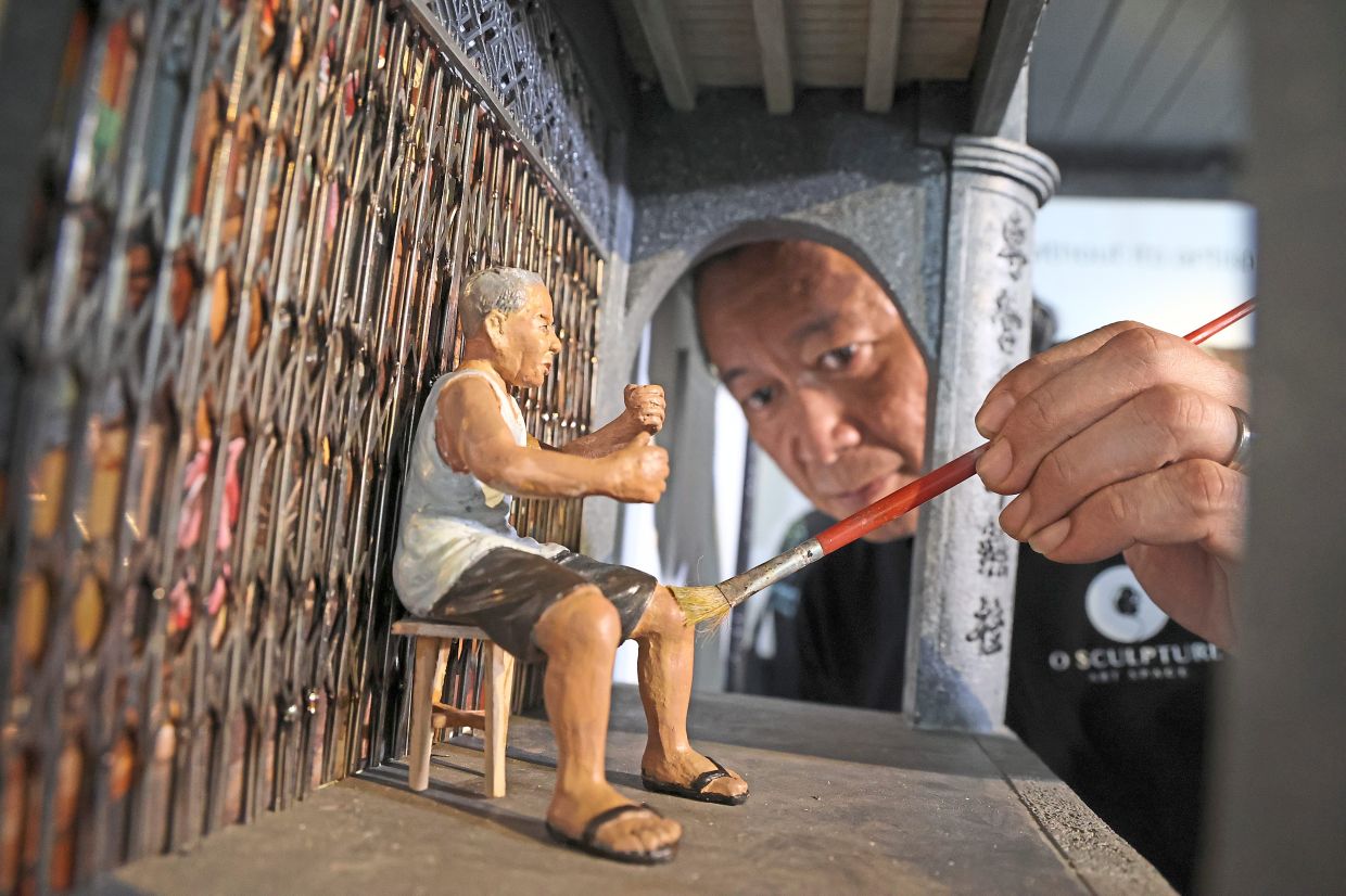 Low putting the finishing touches to his miniature of the proprietor of Lee Hong Huat Chinese medicine hall on Lebuh Pantai, which ceased operations earlier this year. The sculptor says the project, on show at O Sculpture Art Space, has been bittersweet, as it highlights the fragility of the country’s living heritage.