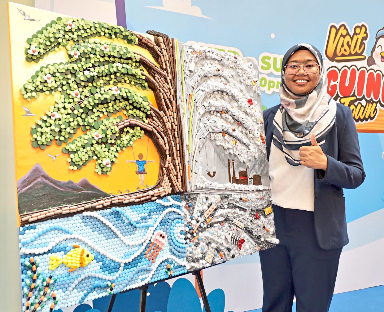 Fadilah with her collage using discarded medicines.