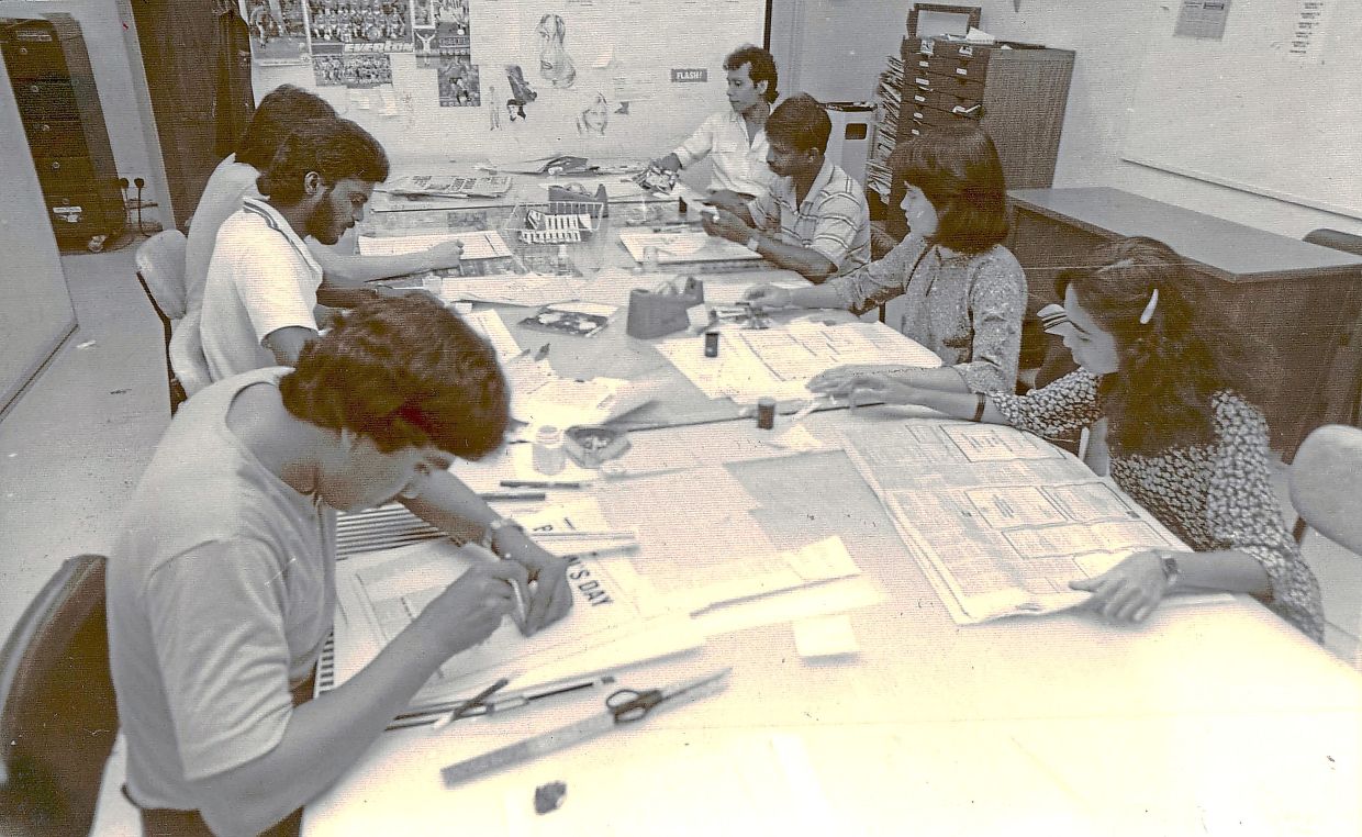 Paste up artists (left) and proof readers hard at work.