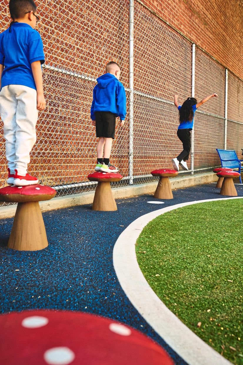 The mushroom stools at Emanuel Kaplan School have bright red tops with white spots and do double-duty as both a place to rest and play.
