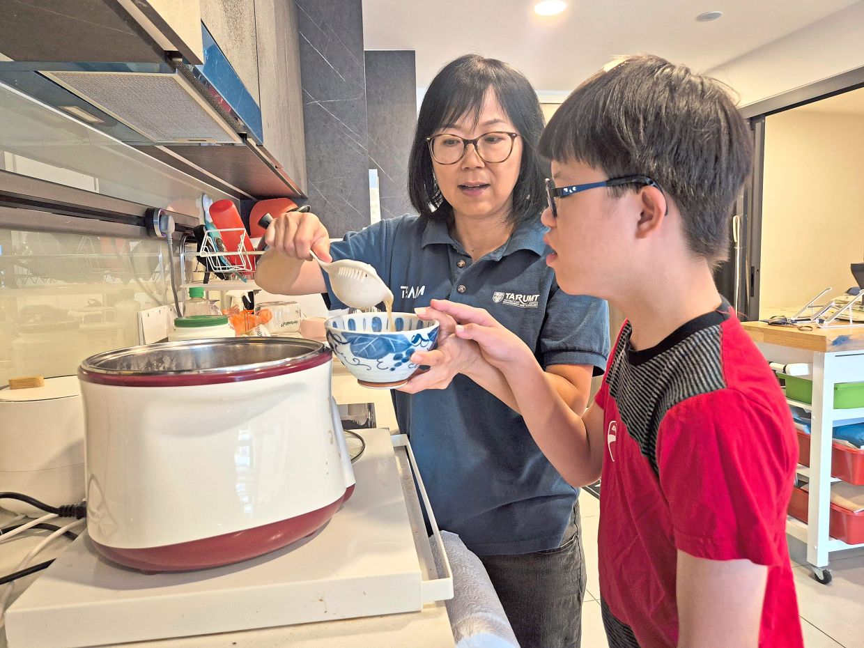 Poh (left) prepares most meals at home to manage expenses while saving for her family’s future needs. Photo: The Star/Sheela Chandran