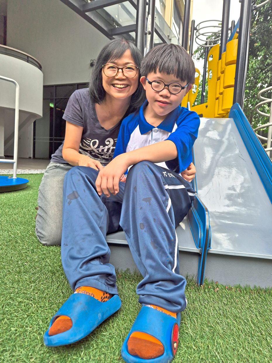 Poh (left) hopes to build a stable financial foundation to support Hau Tze's needs as he grows older. Photo: The Star/Sheela Chandran
