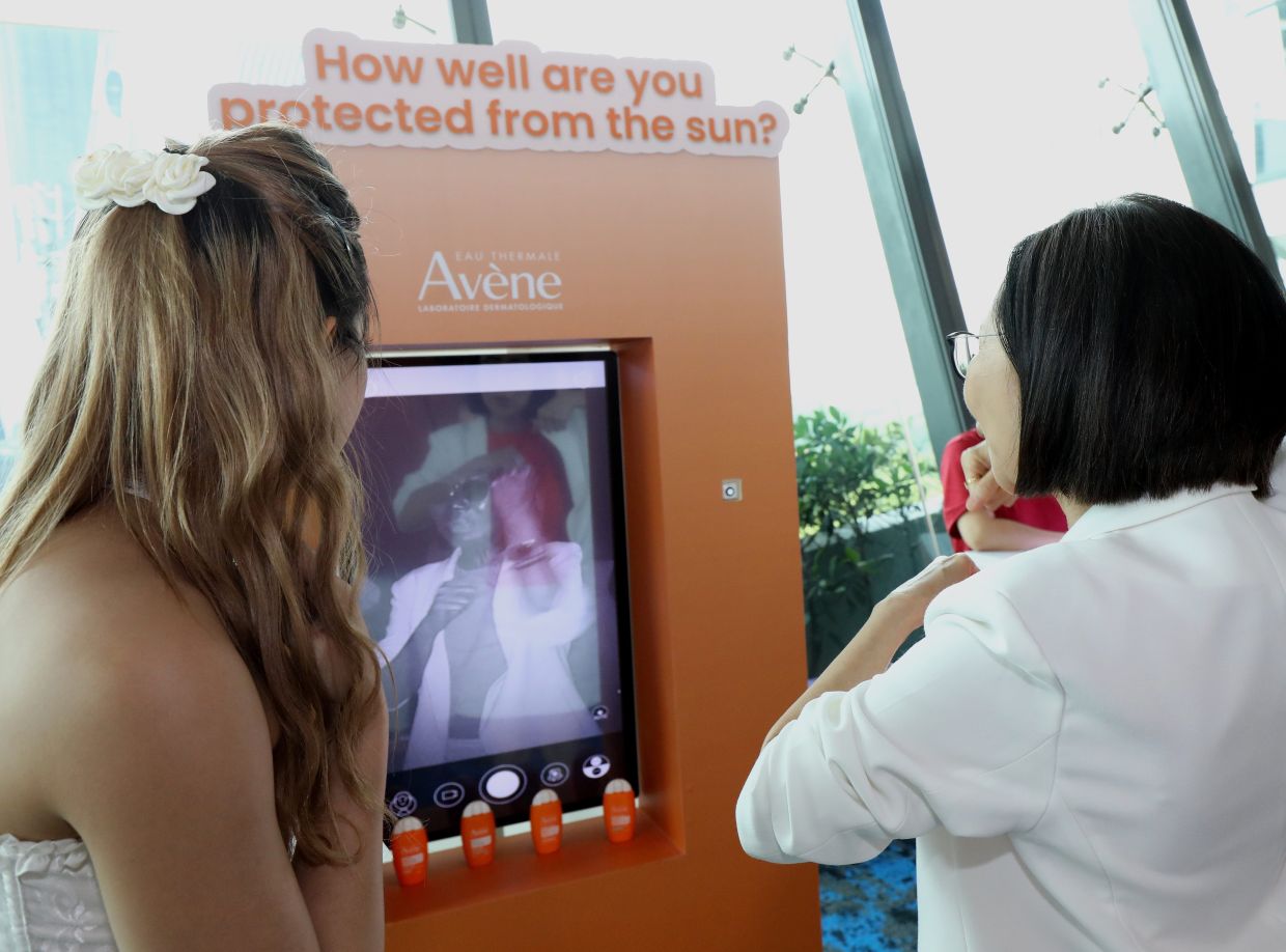 Coverage check: Attendees test their sunscreen coverage at an interactive UV booth that visualises missed areas, highlighting the importance of thorough daily sun protection.