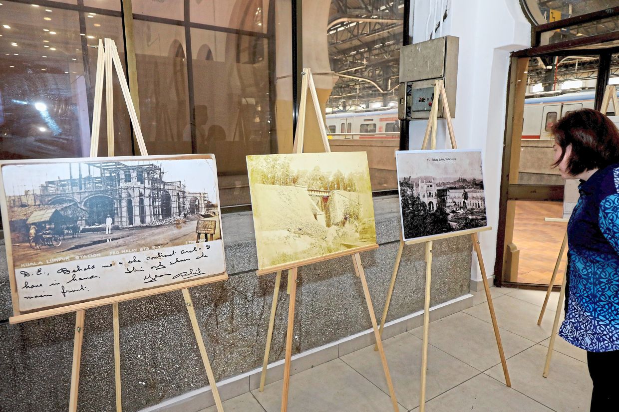 A visitor (left) viewing information on the history of Kuala Lumpur Railway Station, which continues to connect passengers travelling across Peninsular Malaysia.