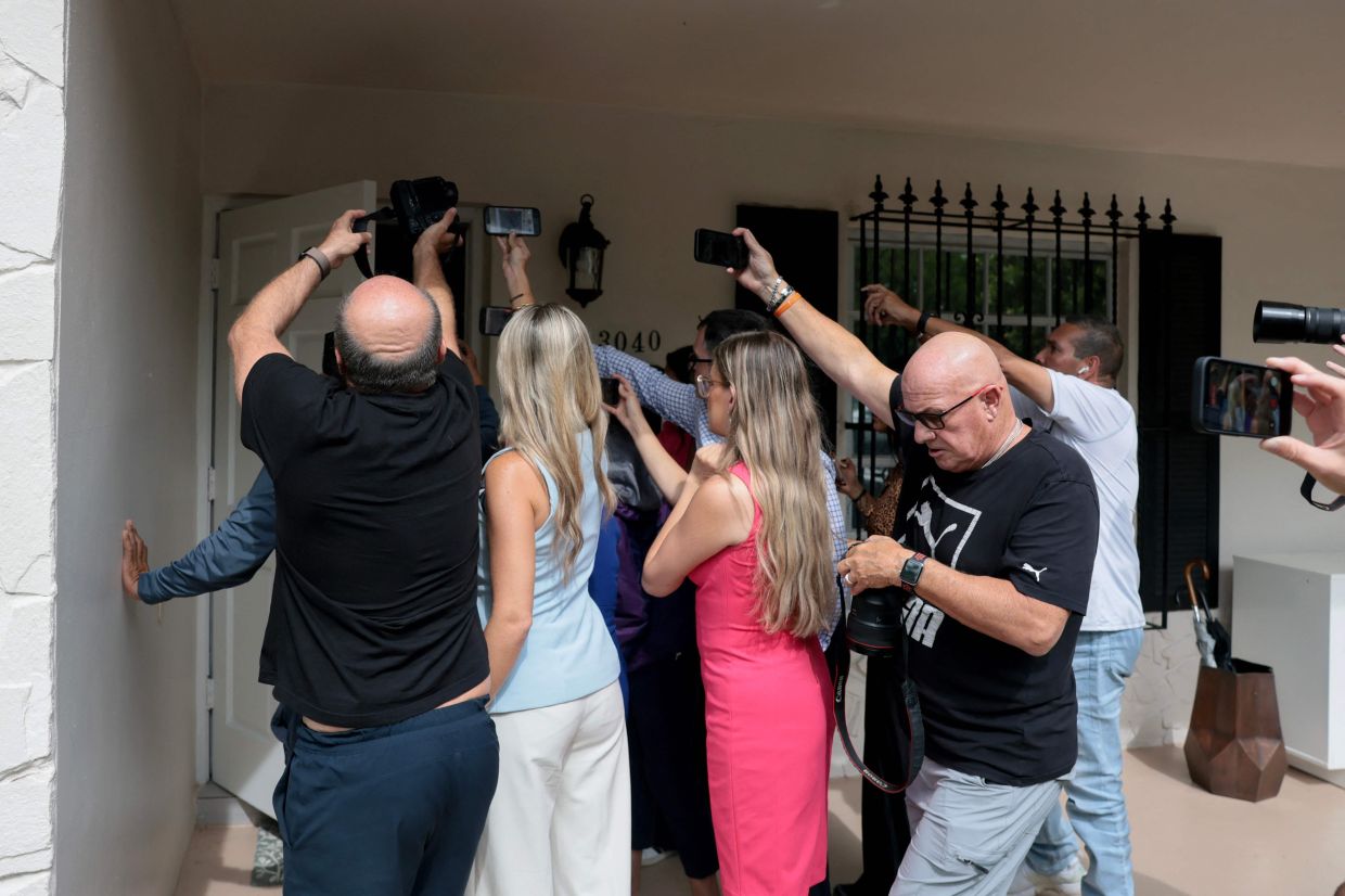 Members of the media crowd around the front door as people enter the home where Perez Hilton was found after he appeared to harm himself during a TikTok livestream. Photo: AFP