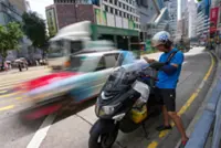 Why are Hong Kong delivery drivers unhappy about proposed payouts for injuries?