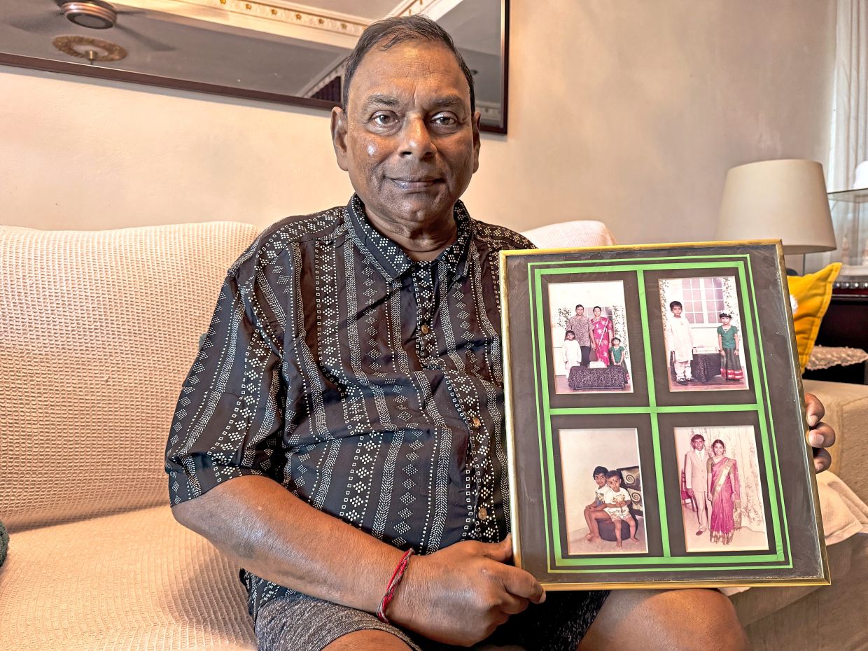 Indrakaran held elaborate naming ceremonies for his two children. He is seen here holding a framed photo of his family.
