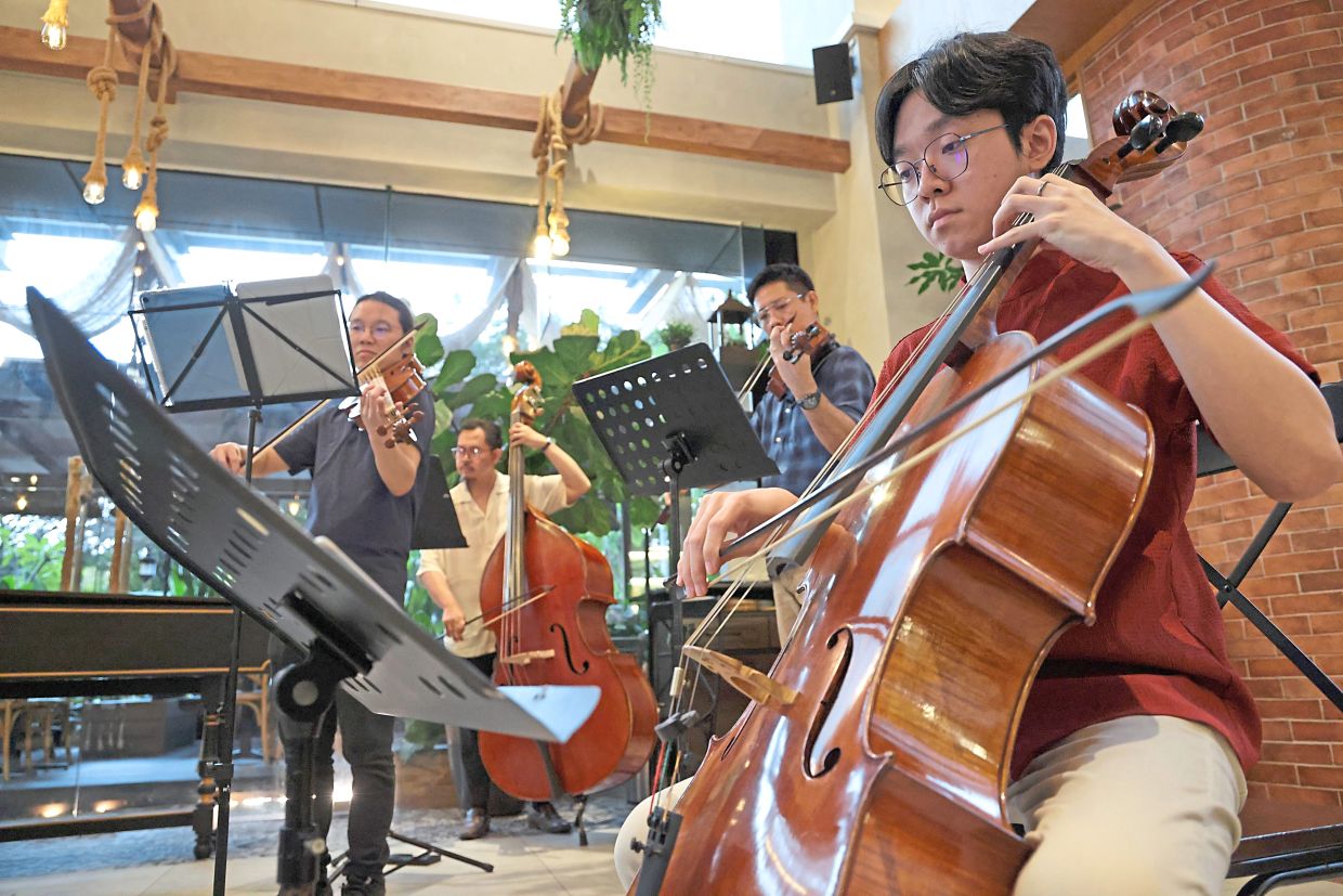 Yap Yi (foreground) with the cello. WMP musicians playing modern instruments also use baroqueperiod bows. Photo: The Star/Glenn Guan
