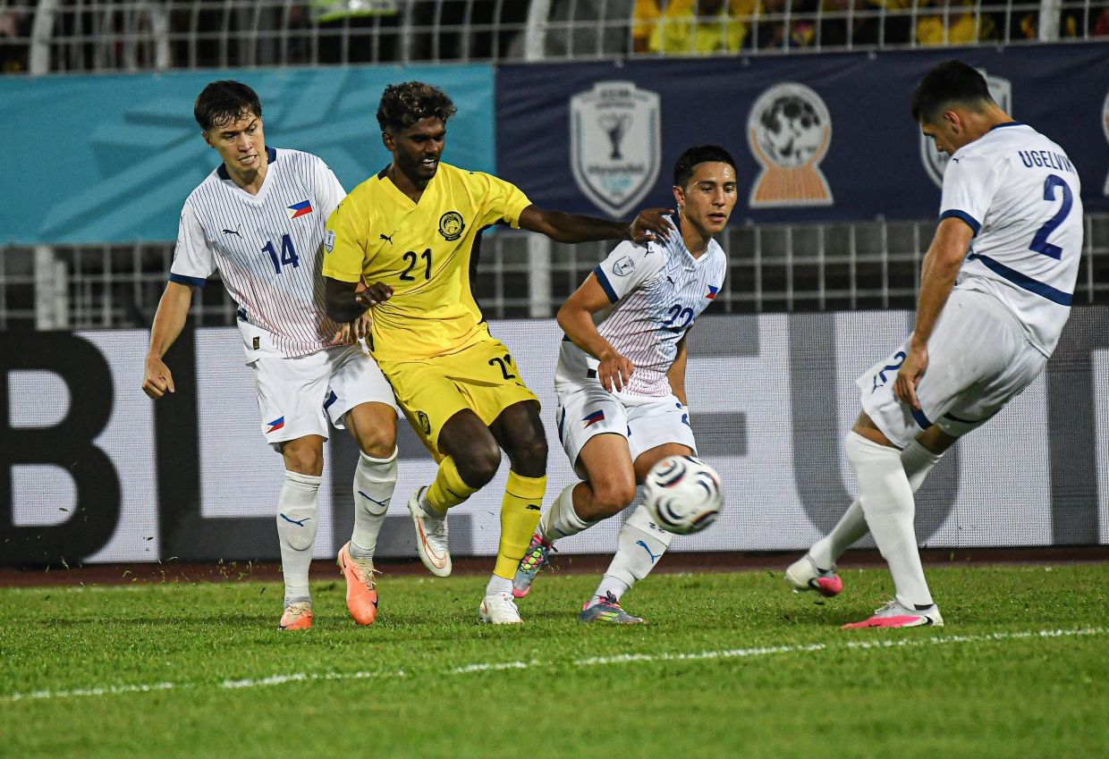 Malaysia goalscorer Pavithran Gunalan attempts to control the ball as two Philippine players challenge for possession during the Group B match of the 2026 Hyundai Asean Cup between Malaysia and the Philippines at the Kuala Lumpur Football Stadium on Saturday (Aug 8, 2026). -- Photo: Bernama