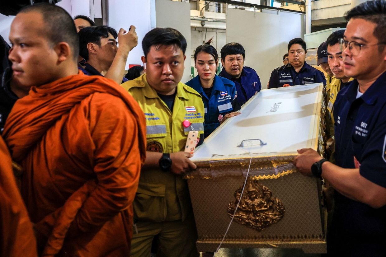 A Buddhist monk leads as workers move a coffin with the body of a victim killed in a deadly shooting at Debsirin Nonthaburi School, at Police General Hospital, in Bangkok, Thailand, on Saturday, August 8, 2026. Photo: REUTERS/Valeria Mongelli