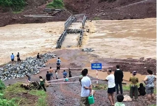 Floods sweep away bridge in northern Vietnam, cut off 400 households