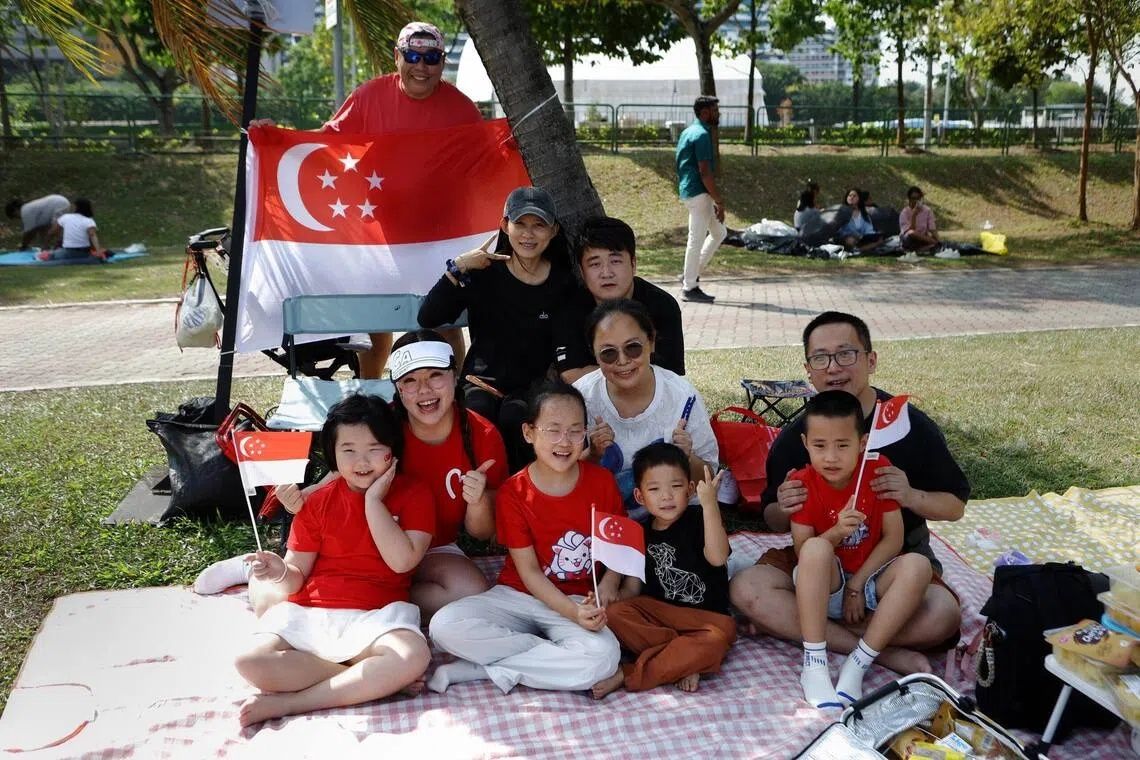 Ho Kien Mun (behind flag), with (first row from left) Ang Shihui, Yifan, Duoduo, Yiji, (second row from left) Zhang Sijuan, Li Ting, Jacky Wang, (third row from left) Dan Na Wu, and Howard Yang, at Republic Avenue on Aug 9. - Photo: ST