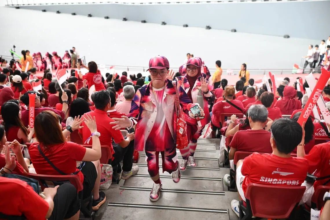 Motivators greeting the spectators before the start of the National Day Parade 2026 at the National Stadium on Aug 9. - Photo: ST