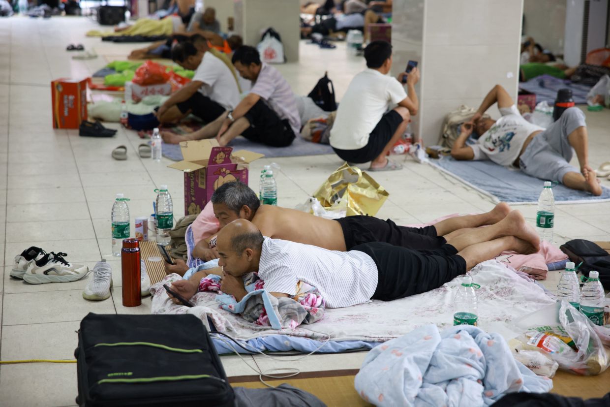 Residents rest after being relocated to a makeshift shelter in a middle school as Typhoon Dolphin approaches, in Yueqing, Wenzhou, Zhejiang province, China, Aug 9, 2026. - Photo: Reuters
