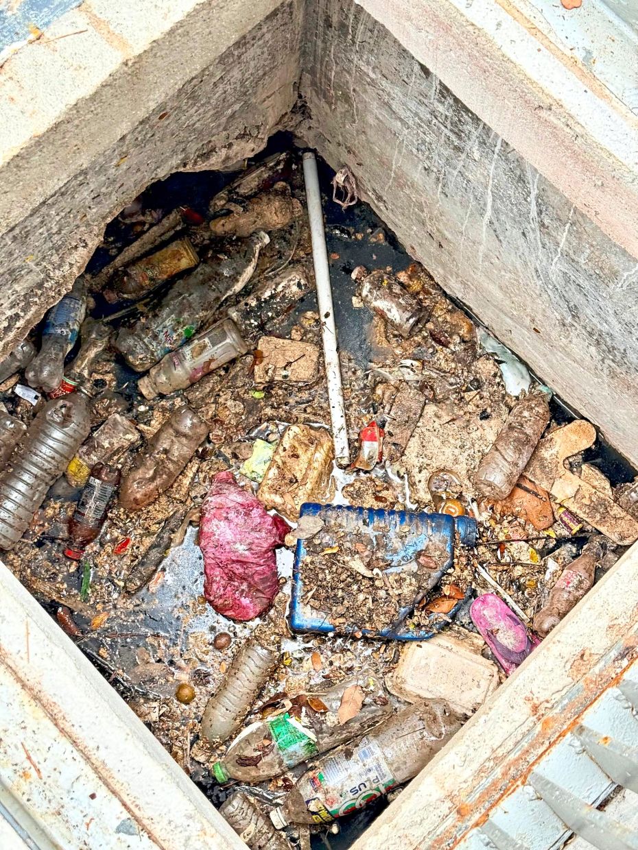 A drain in Taman Maluri choked with rubbish and used cooking oil.