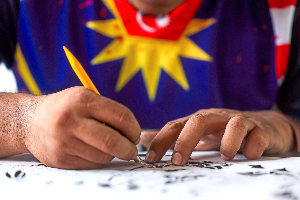 3. Wau maker Mohd Norazizi Mustapha, 45, from Kota Bharu, Kelantan, putting the finishing touches to a wau bulan and a wau kucing ahead of the 2026 Wau Mega Layangan Merdeka competition at Cherang Laut Beach, Kg Senok, Bachok, on aug 30 and 31. He said the kites measure 3.3m to 3.6m and weigh about 3kg each. — Bernama