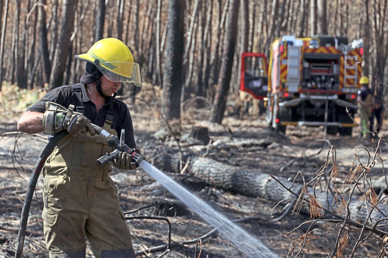 7. A Ukrainian firefighter assisting French units battling a wildfire in Le Porge, France. Wildfires have raged across Europe in recent weeks, particularly in France and Spain, where more than 330,000 people have been evacuated. — Reuters