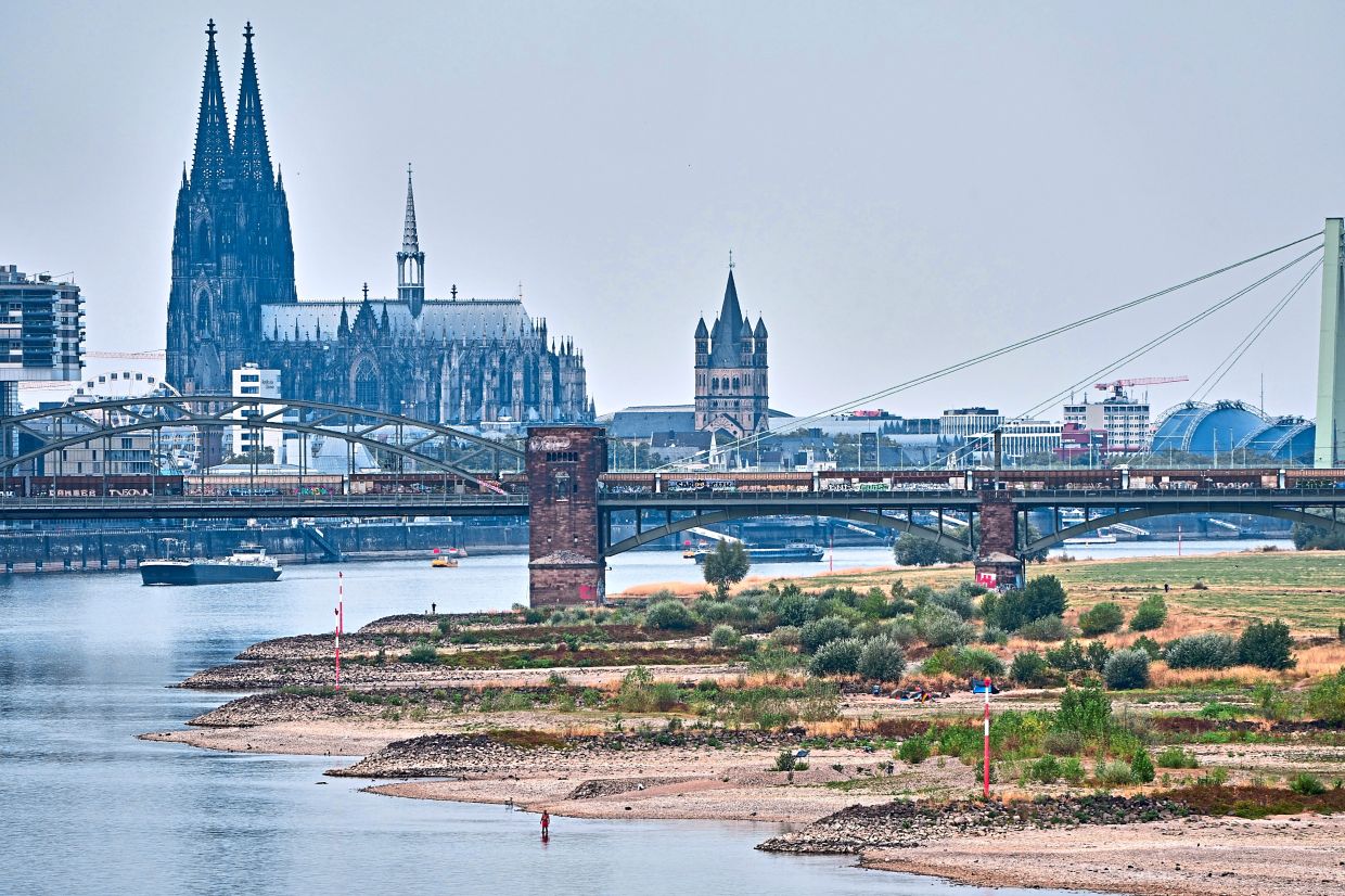 7. Sparse boat traffic is seen on the Rhine near Cologne Cathedral as the river’s water levels drop amid a heatwave andprolonged drought in Cologne, Germany. — AP