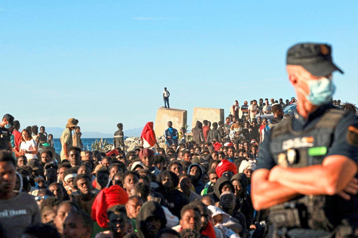 1. Migrants queuing for food and water from the Red Cross in Ceuta, Spain, following a mass influx by land and sea from Morocco. Most of those who arrived were returned within days, while about 100 are believed to have died during the crossing. — Reuters