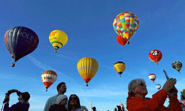 4. People watching hot air balloons take to the skies. Thousands of people attended the Bristol Balloon Fiesta, europe’s largest annual balloon event. —Reuters